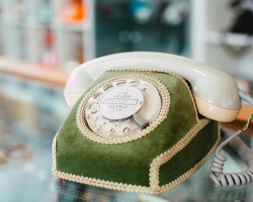 Altmodisches, grünes Telefon mit Wählscheibe